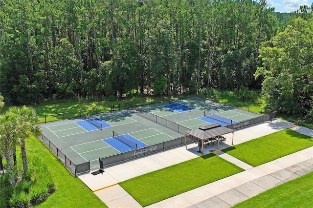 view of sport court featuring a yard