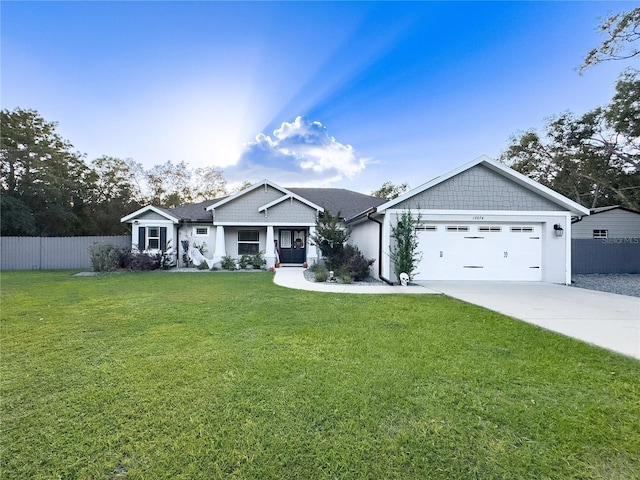 craftsman-style home featuring a front yard and a garage