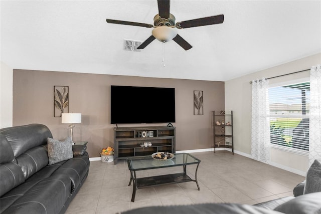 tiled living room with ceiling fan and lofted ceiling