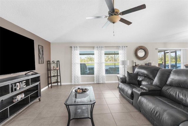 tiled living room featuring a textured ceiling and ceiling fan