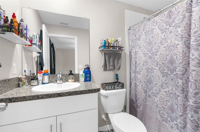 bathroom with vanity, walk in shower, and toilet