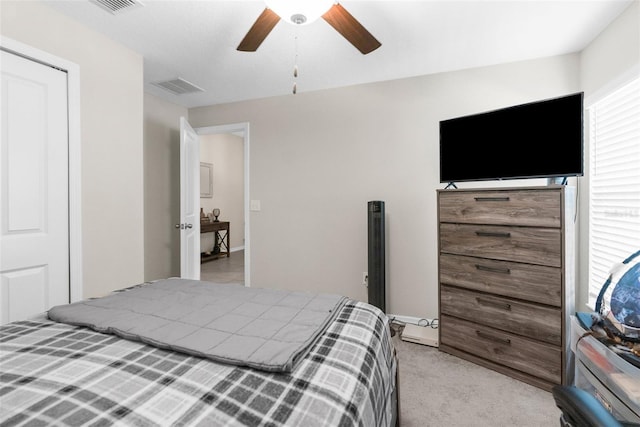 bedroom featuring light colored carpet and ceiling fan