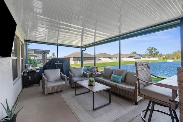 sunroom / solarium featuring a water view