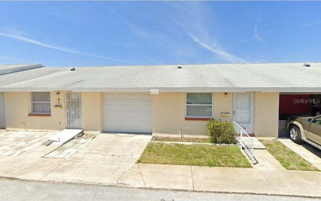 4933 Filner St Unit 4933, New Port Richey, FL 34652 - townhome / multi-family property featuring stucco siding, an attached garage, and concrete driveway