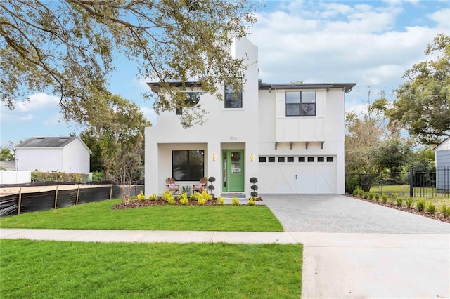 view of front of house with a front yard and a garage