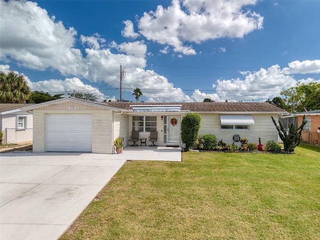 single story home featuring a garage and a front yard