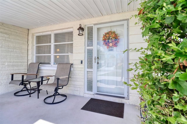 view of exterior entry with covered porch