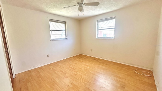 unfurnished room featuring ceiling fan, light hardwood / wood-style flooring, and a textured ceiling