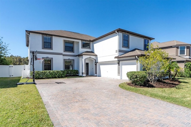 view of front of home featuring a garage and a front lawn