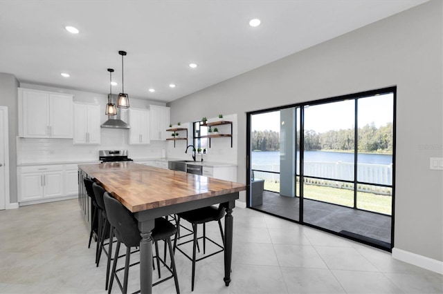 tiled dining area featuring a water view and plenty of natural light