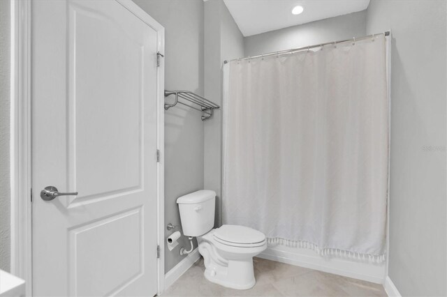 12135 Crestridge Loop, Trinity, FL 34655 - full bathroom featuring toilet, baseboards, tile patterned flooring, and shower / tub combo