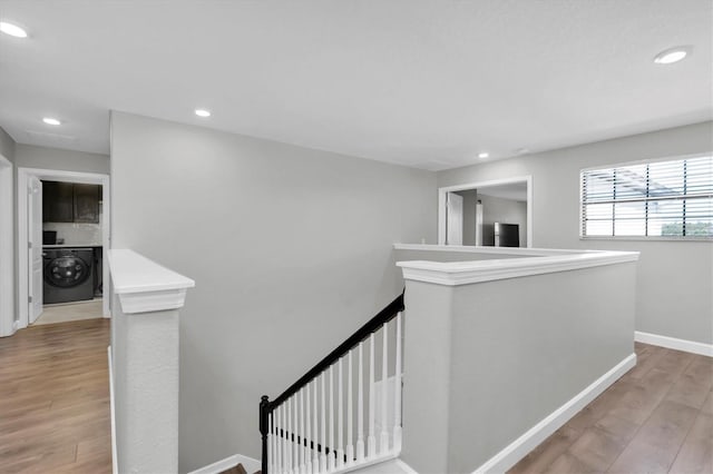 12135 Crestridge Loop, Trinity, FL 34655 - corridor featuring recessed lighting, baseboards, an upstairs landing, washer / dryer, and wood finished floors