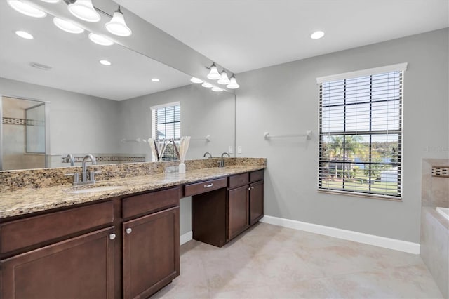 12135 Crestridge Loop, Trinity, FL 34655 - bathroom featuring double vanity, baseboards, recessed lighting, and a sink