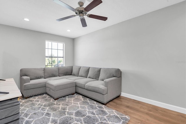 living room with ceiling fan and hardwood / wood-style floors