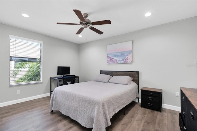 bedroom with ceiling fan and wood-type flooring