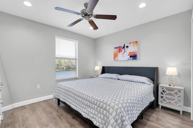 bedroom with hardwood / wood-style floors and ceiling fan