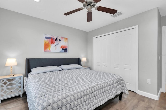 12135 Crestridge Loop, Trinity, FL 34655 - bedroom featuring baseboards, a closet, wood finished floors, and visible vents