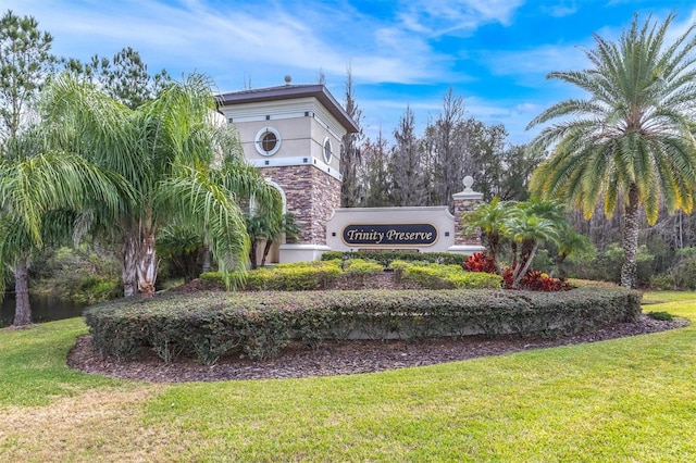 community sign featuring a lawn