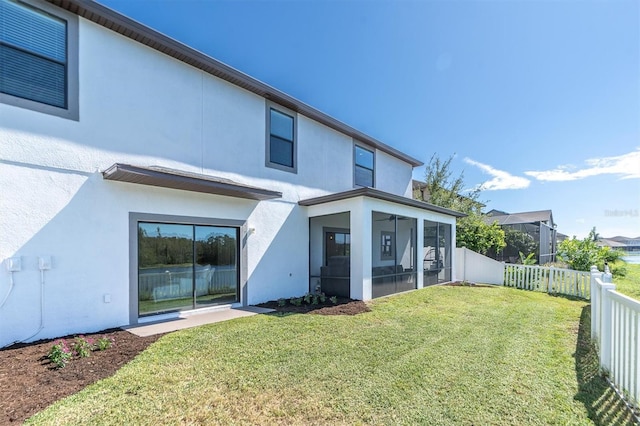 12135 Crestridge Loop, Trinity, FL 34655 - back of property with a sunroom, a fenced backyard, stucco siding, and a yard
