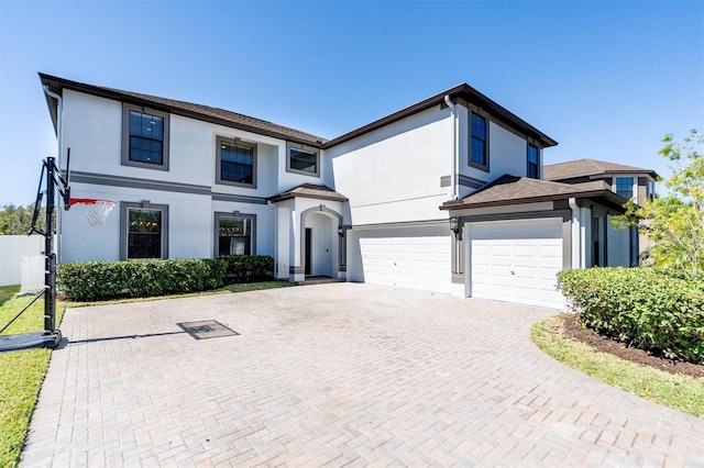 12135 Crestridge Loop, Trinity, FL 34655 - view of front of home with an attached garage, decorative driveway, and stucco siding