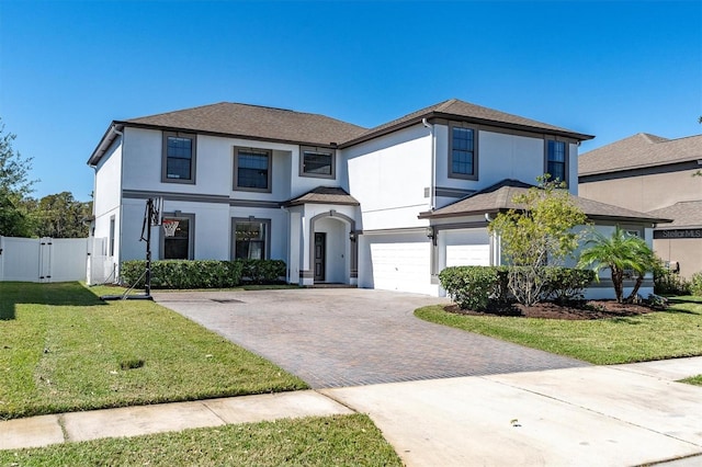 view of front of house with a garage and a front lawn