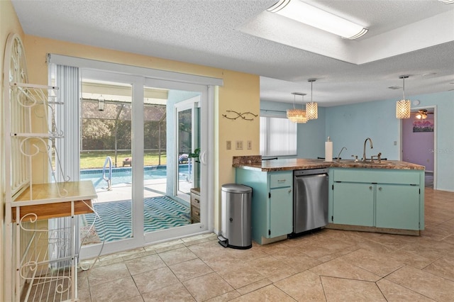 kitchen with kitchen peninsula, a textured ceiling, stainless steel dishwasher, pendant lighting, and sink