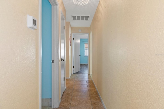 hall with light tile patterned floors