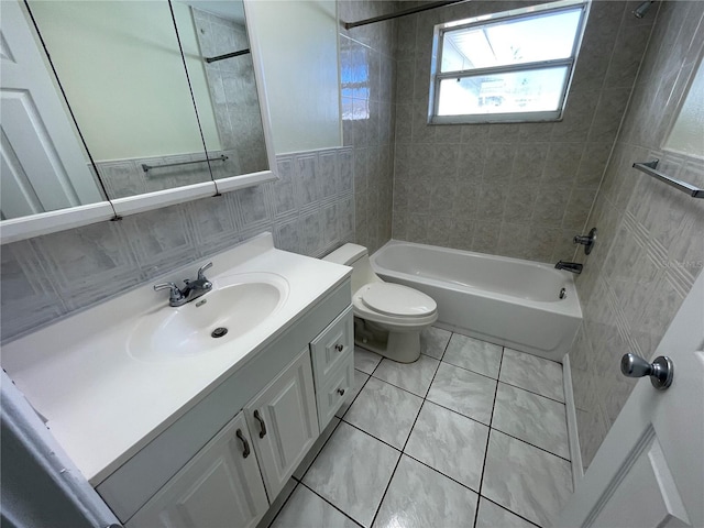 full bathroom with toilet, tile walls, tiled shower / bath, vanity, and tile patterned flooring