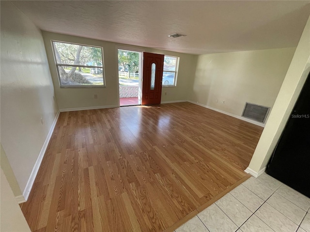 interior space featuring light hardwood / wood-style flooring and a textured ceiling