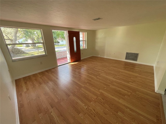 entryway featuring light hardwood / wood-style floors and a textured ceiling