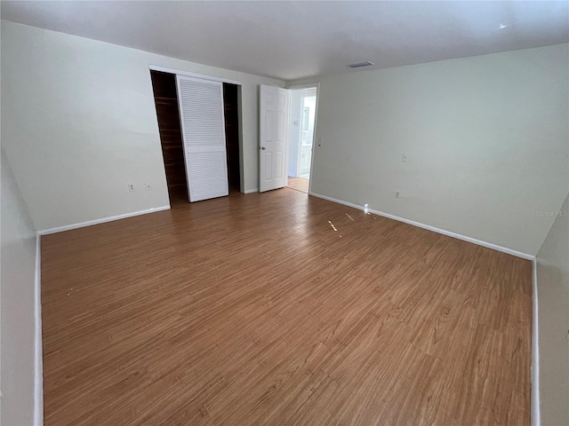 unfurnished room with hardwood / wood-style flooring