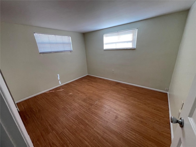 spare room with wood-type flooring