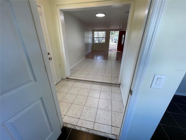 hallway featuring tile patterned flooring