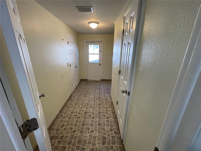 entryway with a textured ceiling