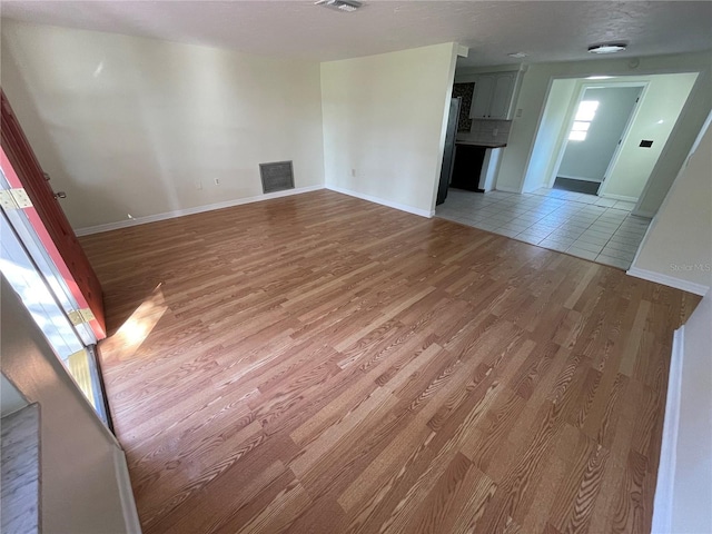 unfurnished living room with light hardwood / wood-style flooring