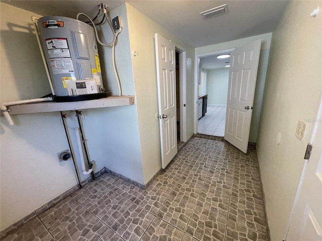 utility room featuring water heater