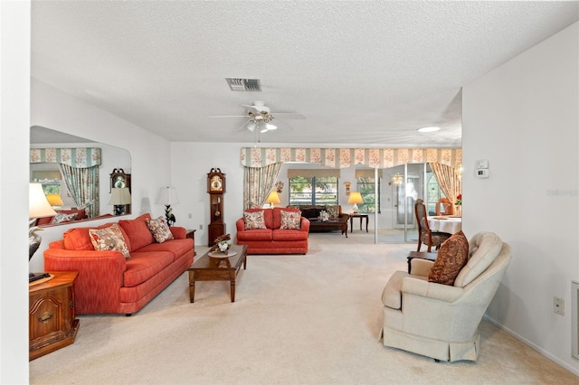 carpeted living room featuring a textured ceiling and ceiling fan