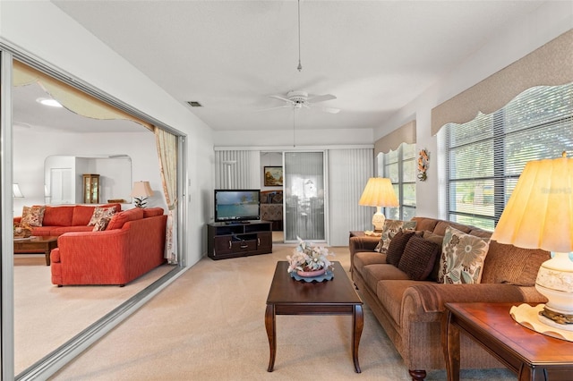 living room featuring carpet floors and ceiling fan