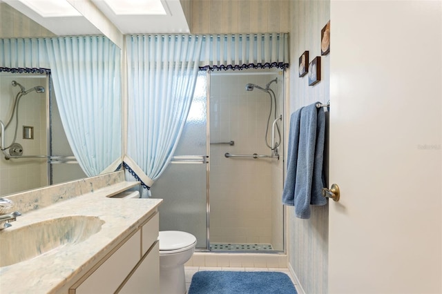 bathroom with vanity, toilet, tile patterned floors, and an enclosed shower