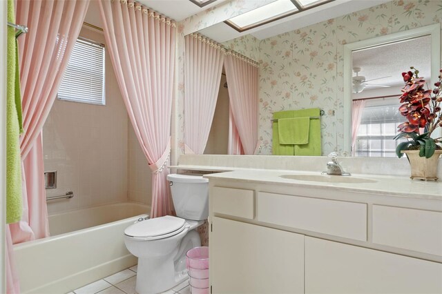 full bathroom with shower / bath combo, toilet, ceiling fan, tile patterned floors, and vanity