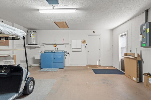 garage with water heater, sink, a garage door opener, electric panel, and washing machine and clothes dryer