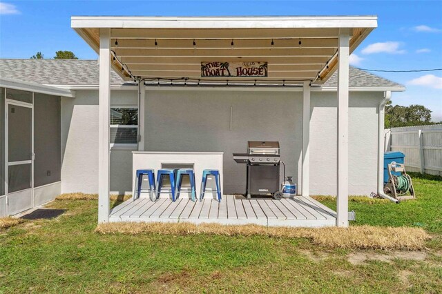 rear view of property featuring a yard