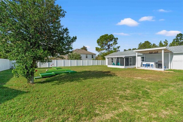 view of yard with a sunroom