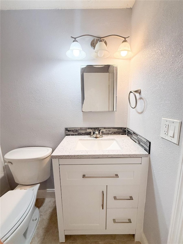 bathroom featuring toilet and vanity