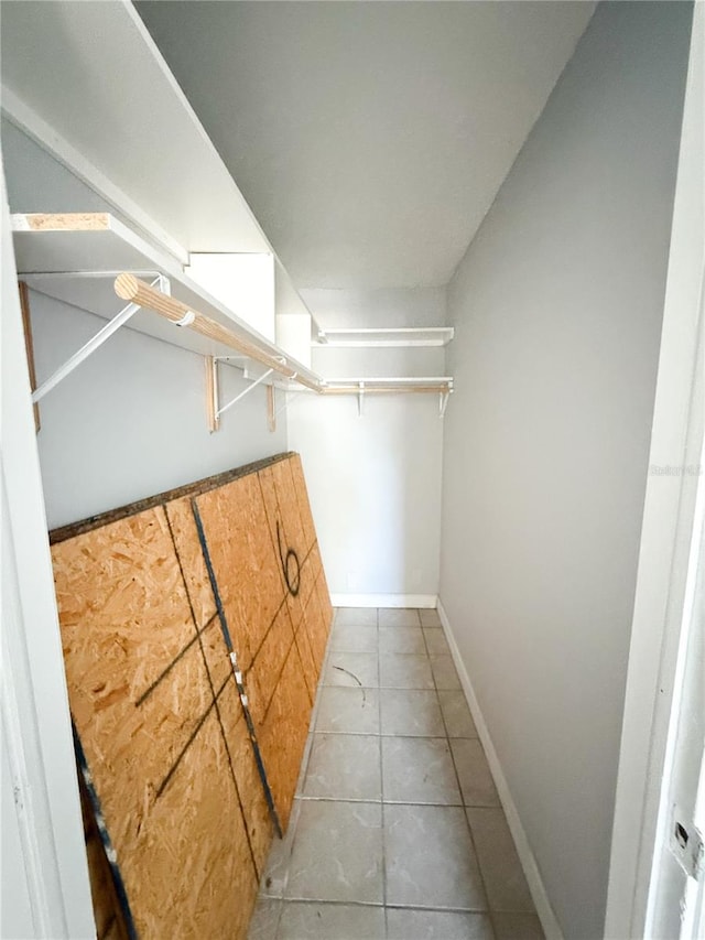 spacious closet with light tile patterned floors