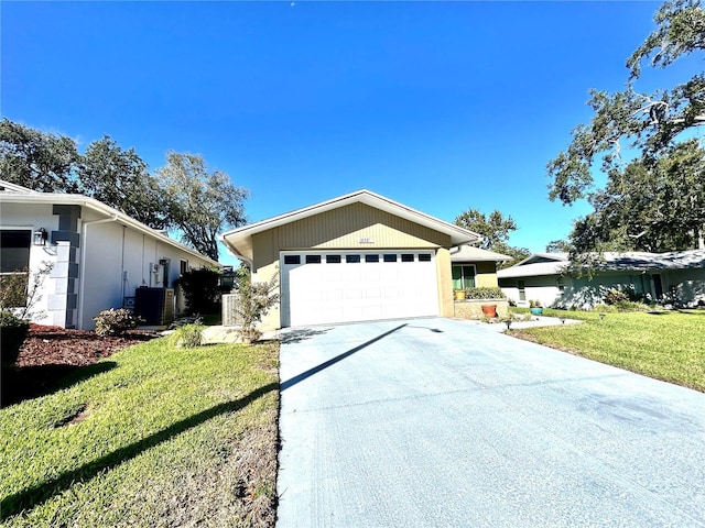 ranch-style house with a garage, cooling unit, driveway, and a front lawn