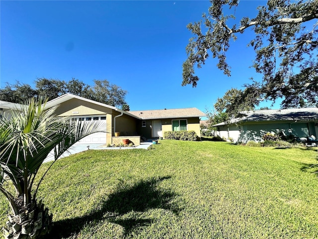 single story home with a front yard and a garage