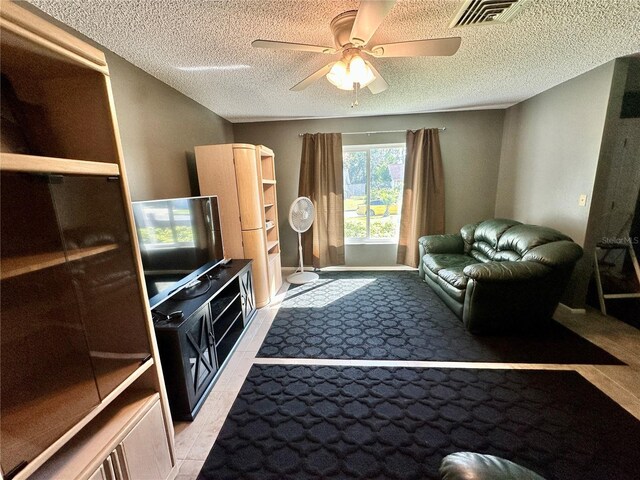10521 Mira Vista Dr, Port Richey, FL 34668 - living room featuring a ceiling fan, a textured ceiling, and light colored carpet