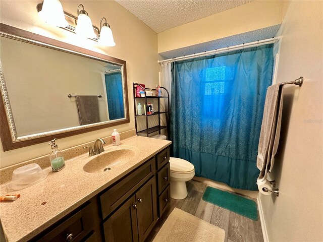 10521 Mira Vista Dr, Port Richey, FL 34668 - full bathroom featuring wood finished floors, a textured ceiling, vanity, and toilet