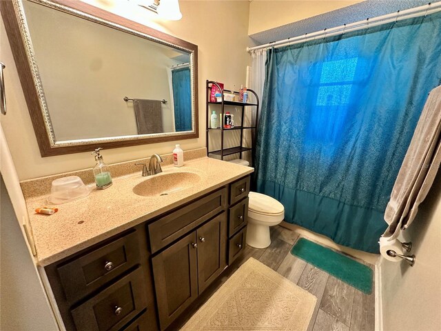 10521 Mira Vista Dr, Port Richey, FL 34668 - bathroom with wood finished floors, vanity, toilet, and curtained shower